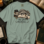 The Plot Thickens T-Shirt: Grumpy Raccoon Reading in Bay - Comfort Colors® T-Shirt