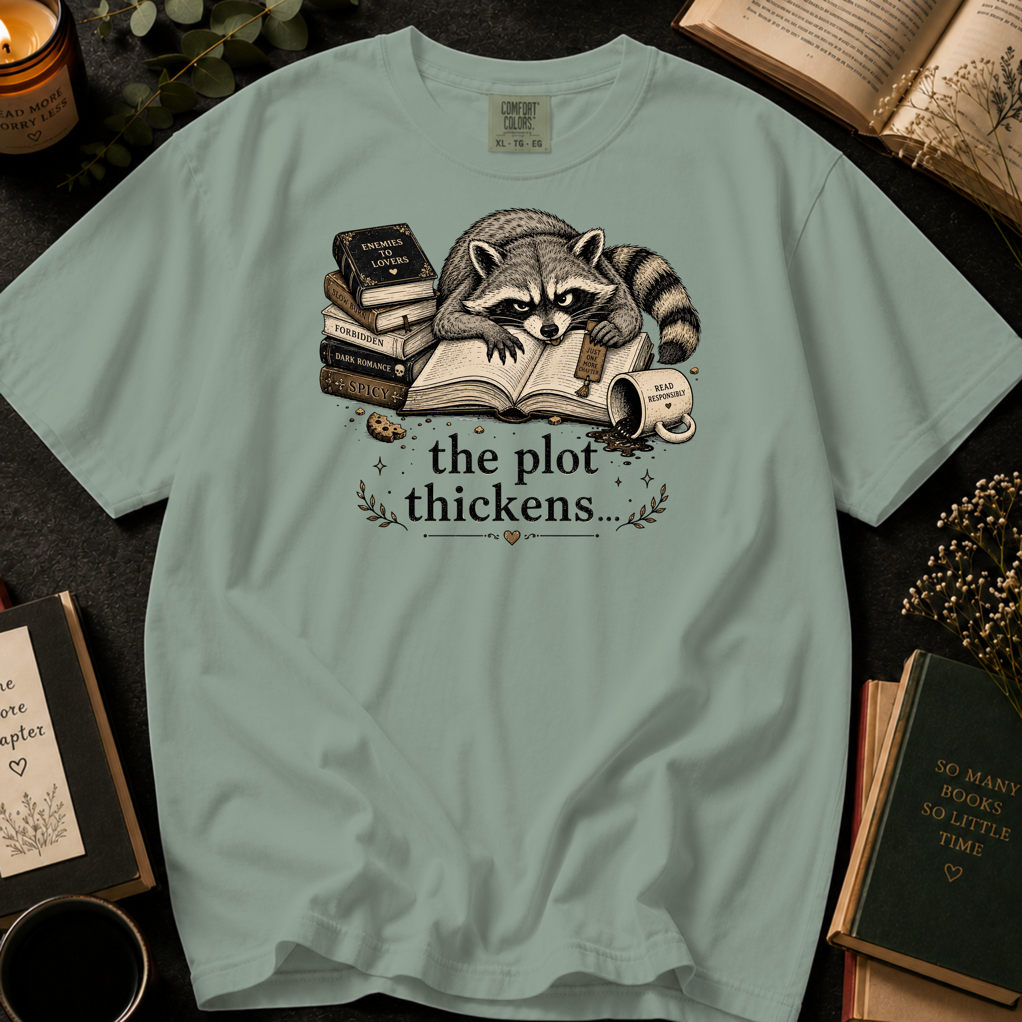 The Plot Thickens T-Shirt: Grumpy Raccoon Reading in Bay - Comfort Colors® T-Shirt