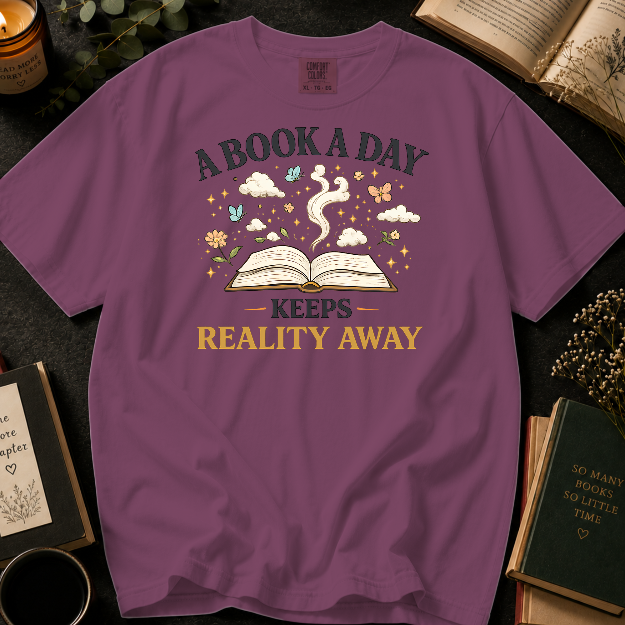 A Book A Day Keeps Reality Away T-Shirt: Whimsical Open Book in Berry - Comfort Colors® T-Shirt