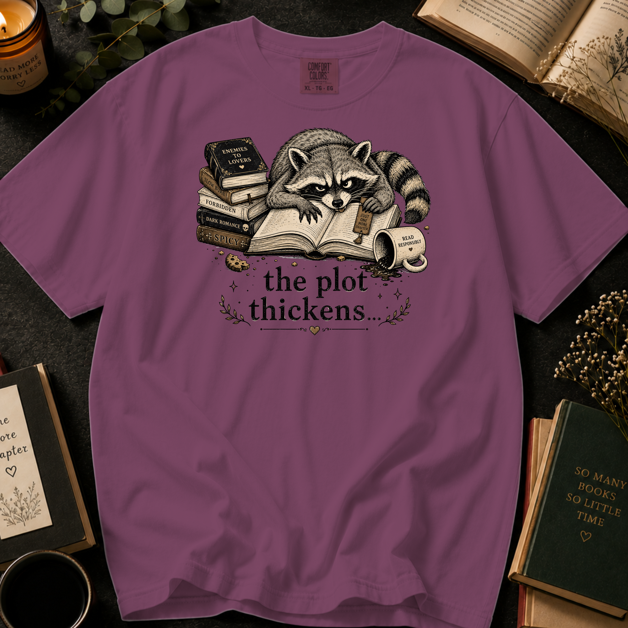The Plot Thickens T-Shirt: Grumpy Raccoon Reading in Berry - Comfort Colors® T-Shirt