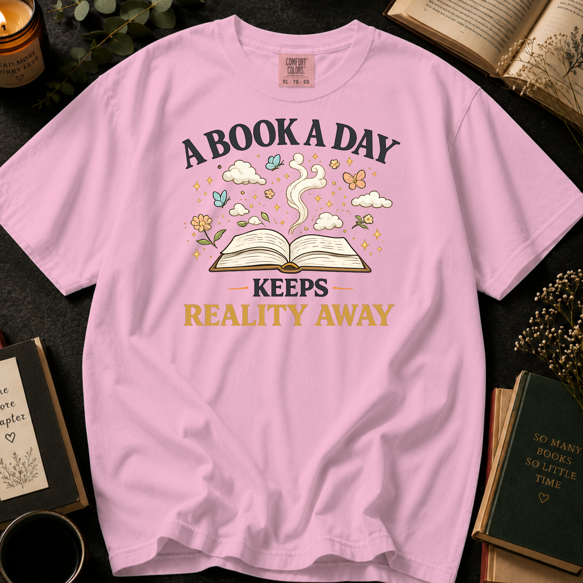 A Book A Day Keeps Reality Away T-Shirt: Whimsical Open Book in Blossom - Comfort Colors® T-Shirt