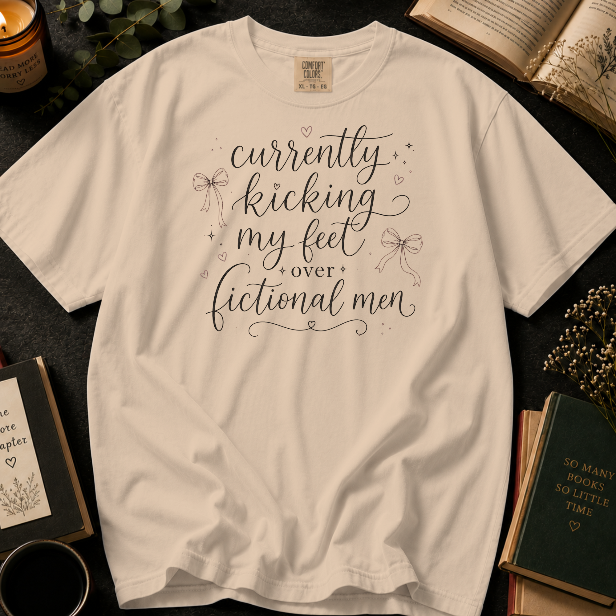 Currently Kicking My Feet Over Fictional Men T-Shirt: Script and Bows in Ivory - Comfort Colors® T-Shirt