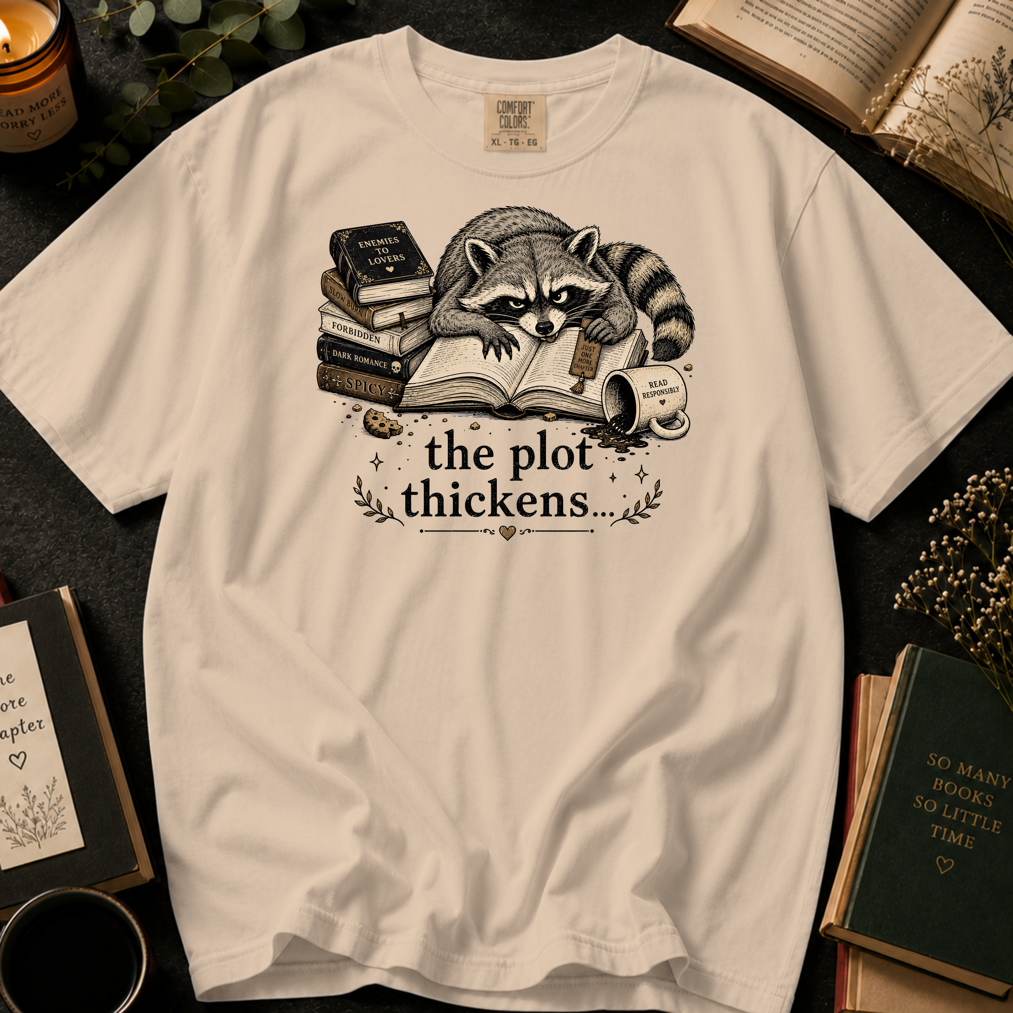 The Plot Thickens T-Shirt: Grumpy Raccoon Reading in Ivory - Comfort Colors® T-Shirt