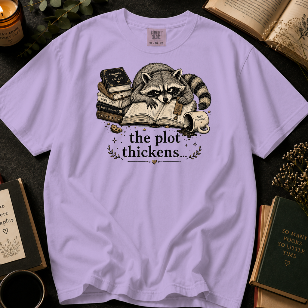 The Plot Thickens T-Shirt: Grumpy Raccoon Reading in Orchid - Comfort Colors® T-Shirt