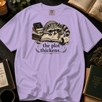 The Plot Thickens T-Shirt: Grumpy Raccoon Reading in Orchid - Comfort Colors® T-Shirt
