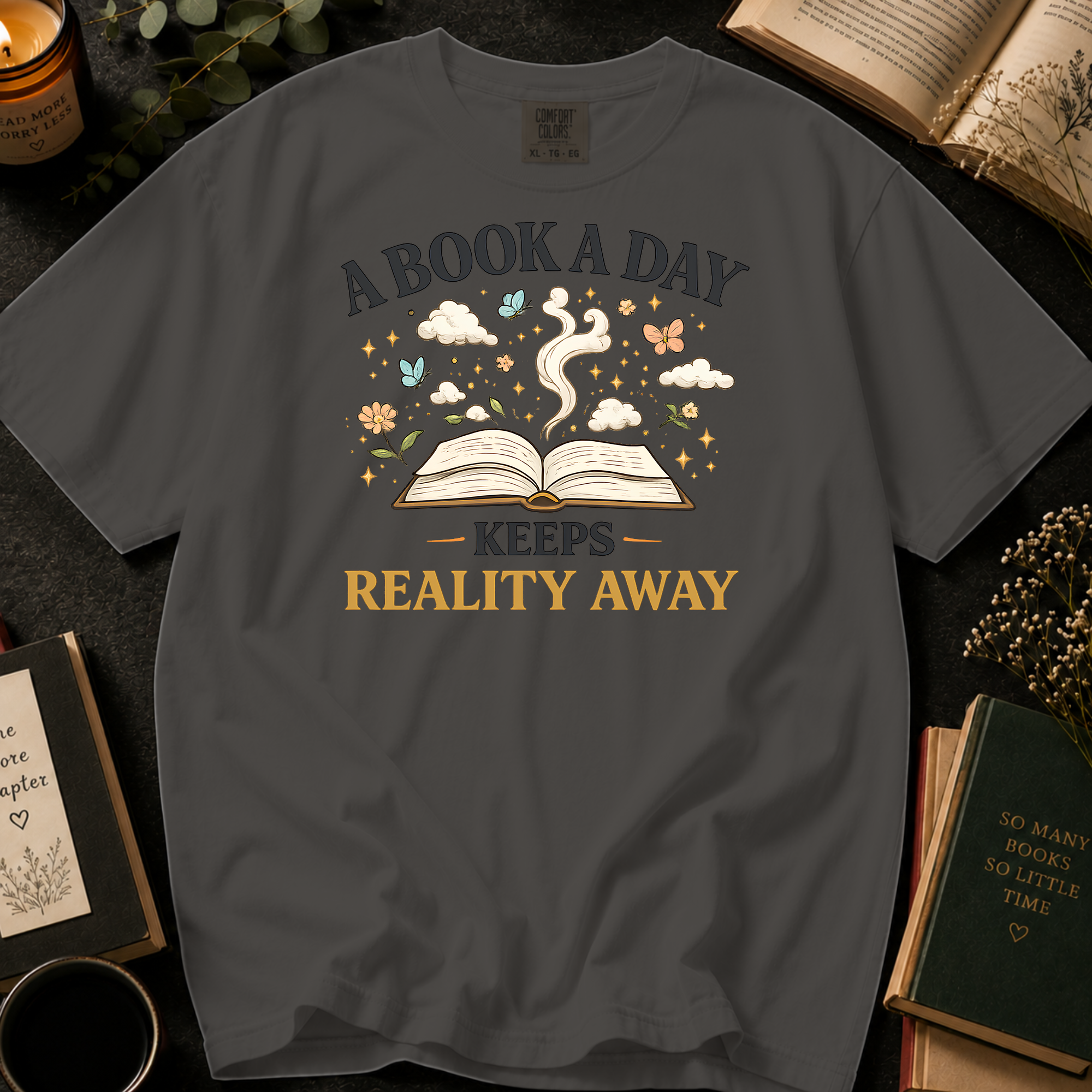 A Book A Day Keeps Reality Away T-Shirt: Whimsical Open Book in Pepper - Comfort Colors® T-Shirt