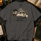 The Plot Thickens T-Shirt: Grumpy Raccoon Reading in Pepper - Comfort Colors® T-Shirt